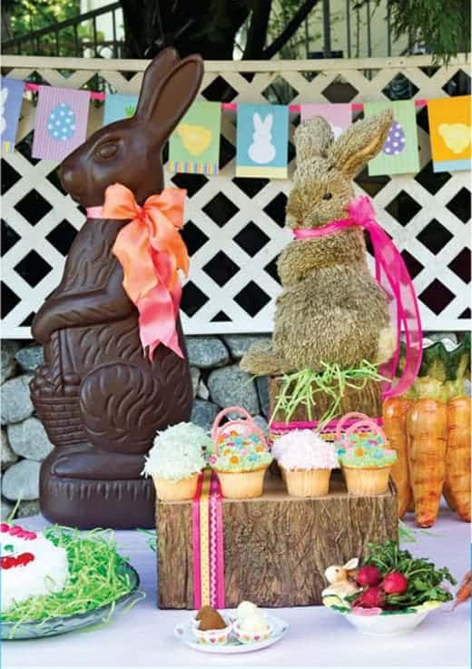 chocolate bunny and stuffed bunny with spring flag banner